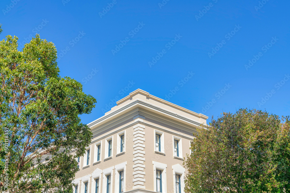 Corner part of a beige building against the clear sky background in San Francisco, California Corner part of a beige building against the clear sky background in San Francisco, California