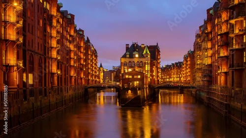 Hamburg, Germany. Night view of Speicherstadt in Hamburg, Germany. Time-lapse with illuminated historical buildings at sunset with reflection in the water, zoom in photo