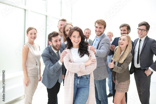 confident young woman standing in front of the business team.