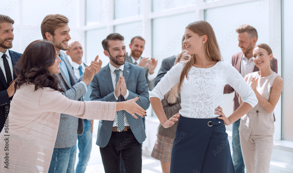 young business woman shaking hands with her colleague young business woman shaking hands with her colleague