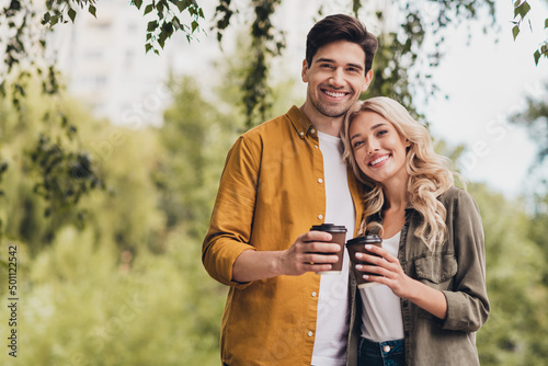 Portrait of beautiful handsome amorous cheerful life partners spending free spare time drinking latte cappuccino outdoors