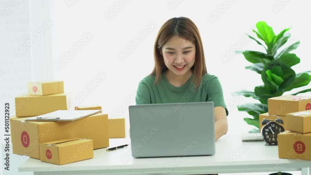 Young Asian businesses start with an online business or an idea. SME young women working with boxes at home and laptops to take name orders and deliver. Young Asian businesses start with an online business or an idea. SME young women working with boxes at home and laptops to take name orders and deliver.