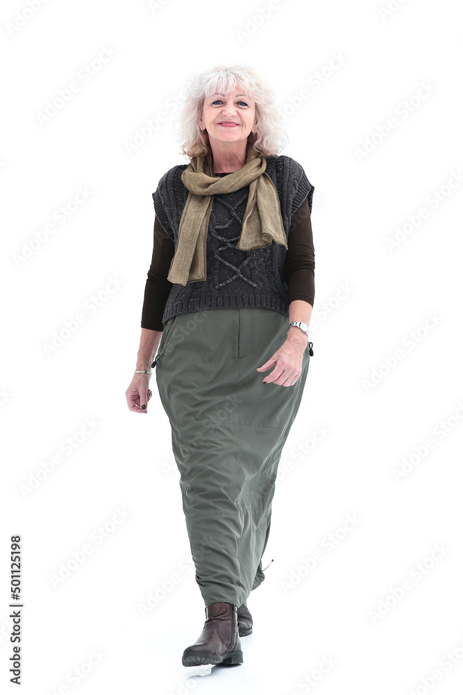 in full growth. smiling adult woman striding forward