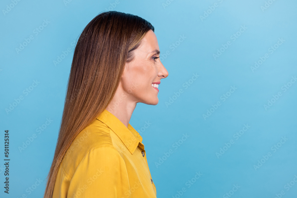 Profile photo of optimistic mature brown hairdo lady look promo wear yellow shirt isolated on blue color background Profile photo of optimistic mature brown hairdo lady look promo wear yellow shirt isolated on blue color background
