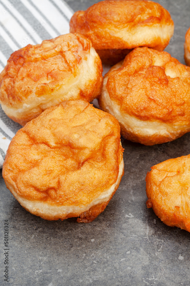 South African vetkoek, deep fried savory dough, on mottled grey background with copy space South African vetkoek, deep fried savory dough, on mottled grey background with copy space