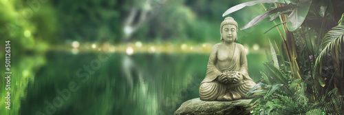 Obraz na płótnie buddha statue on a rock lakeside, natural spa background with asian spirit, tran