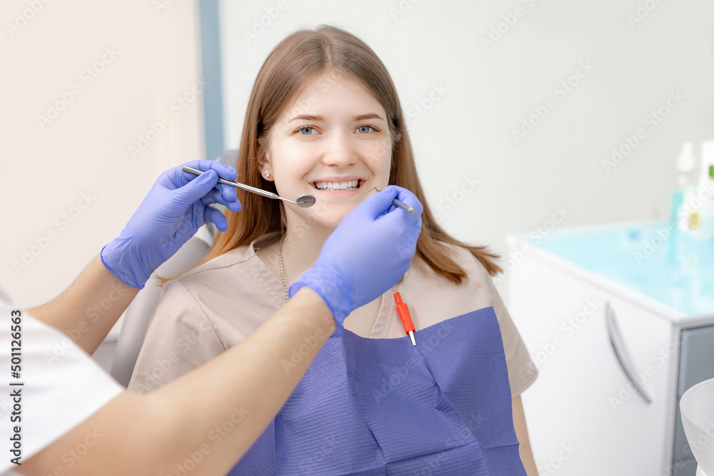 Happy young brunette woman at dentist checks her smile teeth Happy young brunette woman at dentist checks her smile teeth