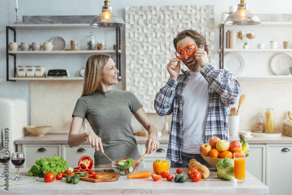 Smiling funny young european husband with stubble have fun, put pieces of pepper to eyes Smiling funny young european husband with stubble have fun, put pieces of pepper to eyes