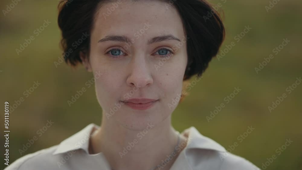 Close up portrait of woman with brown hair and blue eyes Close up portrait of woman with brown hair and blue eyes