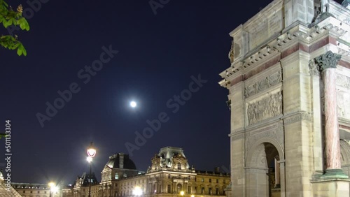 Illuminated Arc de Triomphe du Carrousel at night timelapse photo