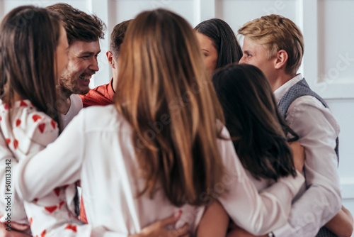 Group of friends are having fun, they are hugging closely