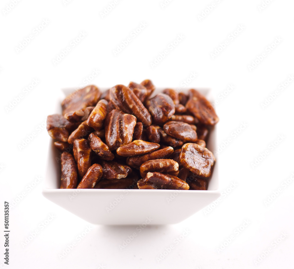 Bowl of Candied Pecans on a White Background Bowl of Candied Pecans on a White Background