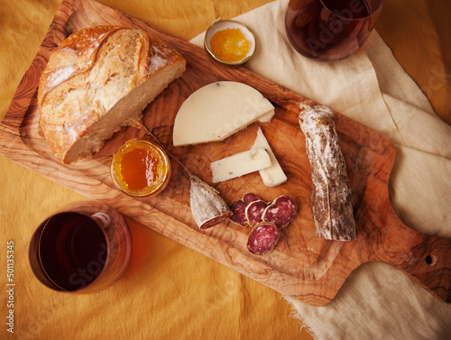 Salami, Cheese, Bread and Marmalade on a Wooden Board photo