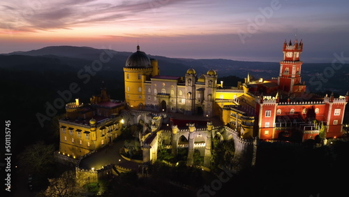 Aerial view of stunning Pena Castle at night. Top view of illuminated Sintra