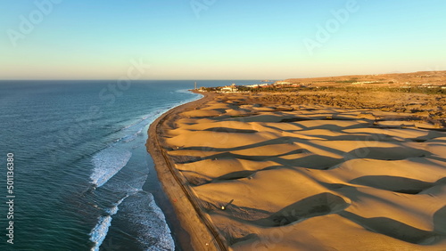 Sand dunes meet the Atlantic Ocean. Top view of Maspalomas