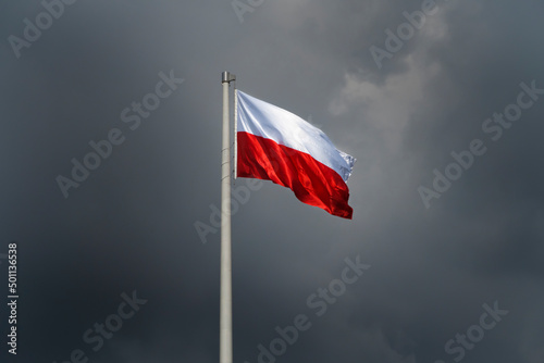 Flaga Polski na tle burzowego nieba photo