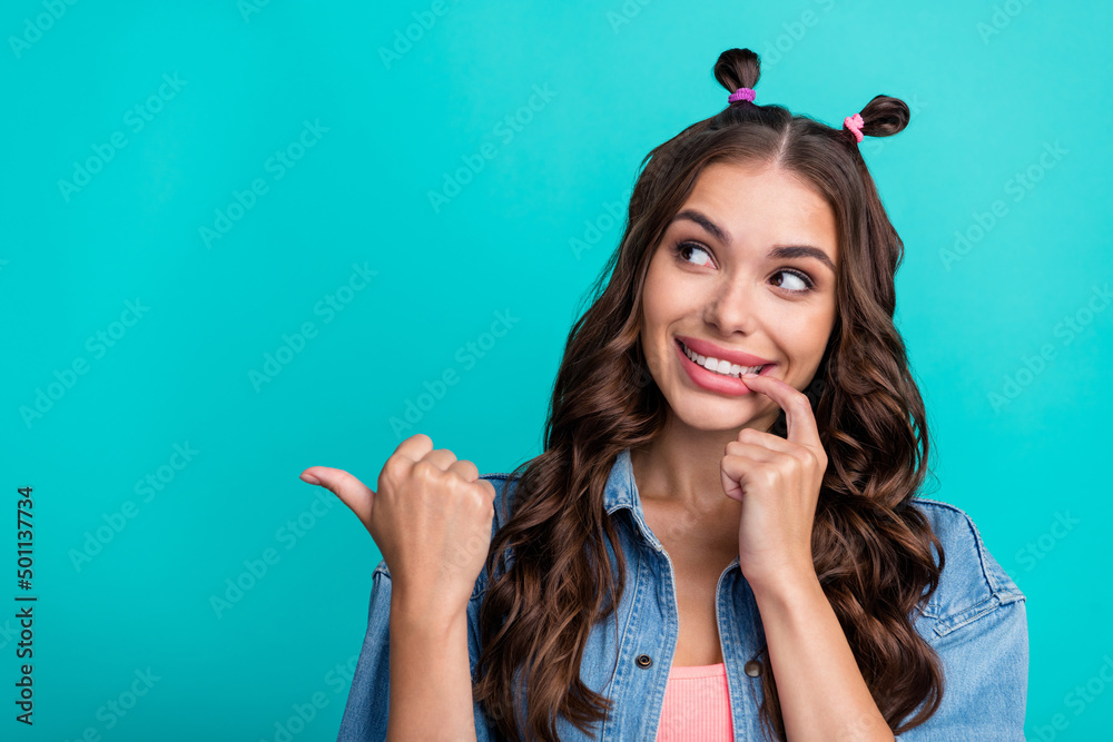 Photo of young cheerful girl curious look indicate thumb empty space proposition discount isolated over turquoise color background Photo of young cheerful girl curious look indicate thumb empty space proposition discount isolated over turquoise color background