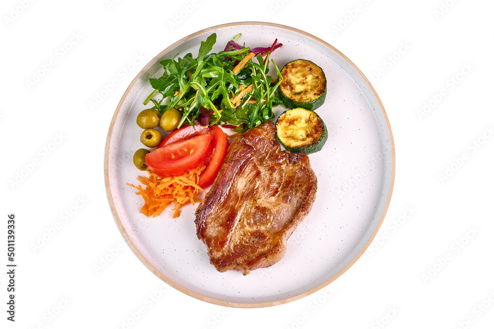 Grilled pork steaks with vegetable salad, isolated on white background.