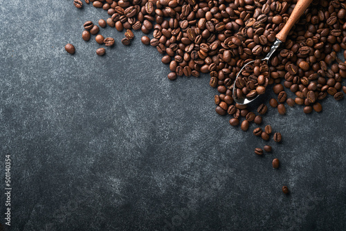 Coffee beans background. Roasted Coffee beans on dark black stone background. Top view. Coffee concept. Mock up.