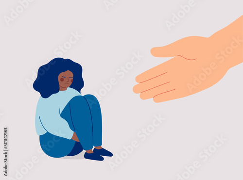 Human hand helps a sad black woman to get rid of anxiety. The counselor supports the African American girl with psychological problems. Mental health aids and medical help for people under depression