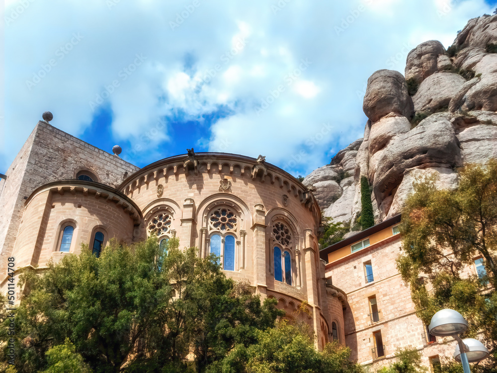 Catholic monastery of Montserrat on the background of round rocks. Blue sky. Catalonia, Spain.