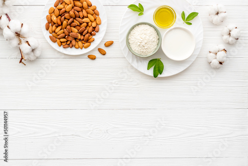 Sweet almond oil and milk with nuts seeds. Healthy food and cosmetic background