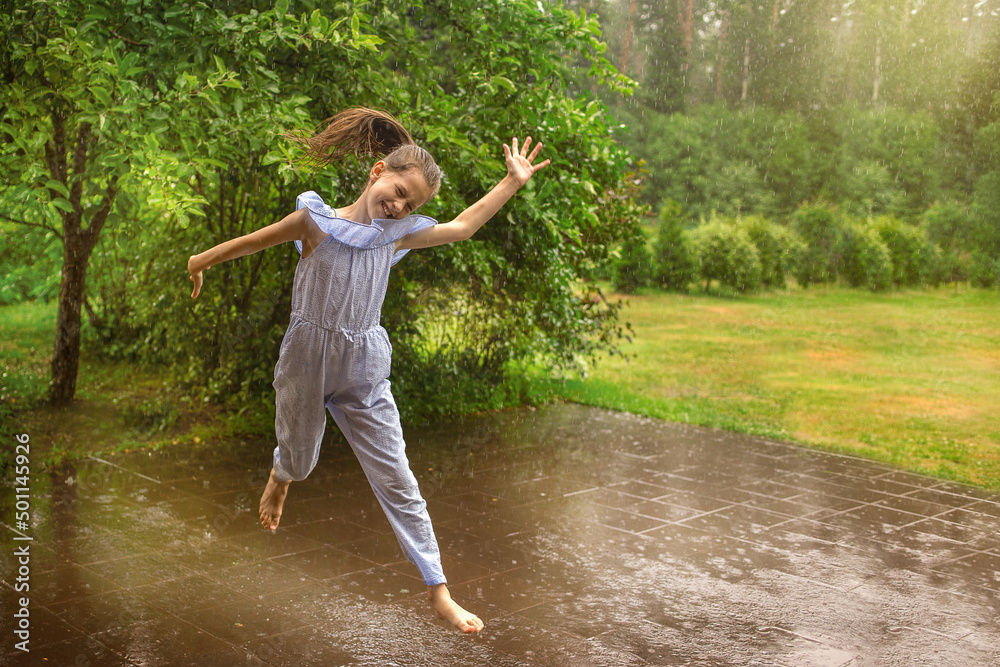 Girl jumps barefoot in the rain