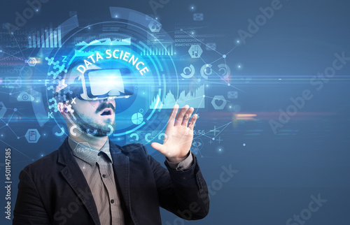 Businessman looking through VR glasses