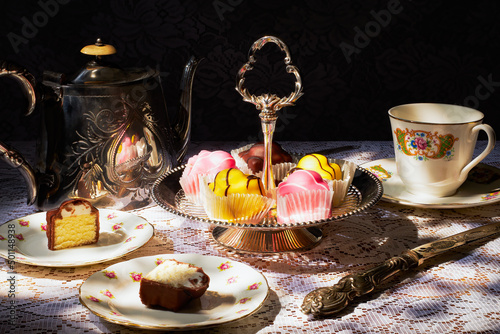 Vintage tea party, with french fancies.  The teapot, cake stand, plates and teacup are all vintage.