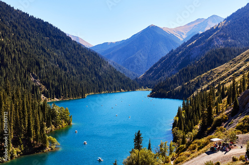 view of a mountain lake surrounded by forest