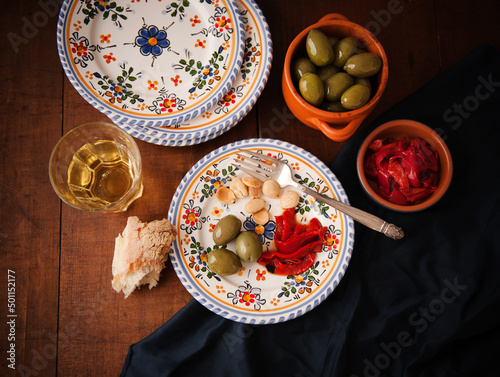Plate with a Single Serving of Tapas; Green Olives, Roasted Red Peppers and Almonds; Bread and White Wine