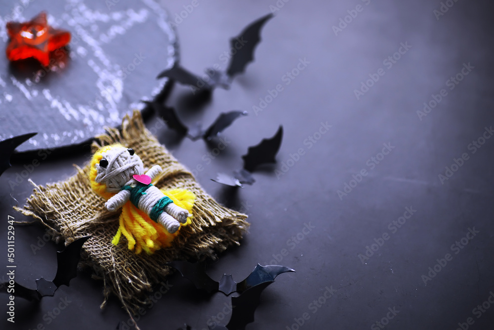 Halloween holiday concept. Old stone table in a shape of bats. Halloween paper decorations on dark background. Moon toy. Halloween holiday concept. Old stone table in a shape of bats. Halloween paper decorations on dark background. Moon toy.