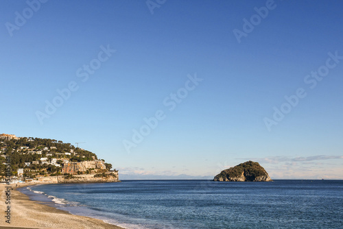 Seascape with the promontory of Punta Predani and the small Island of Bergeggi in the Riviera di Ponente, Bergeggi, Savona, Liguria, Italy photo