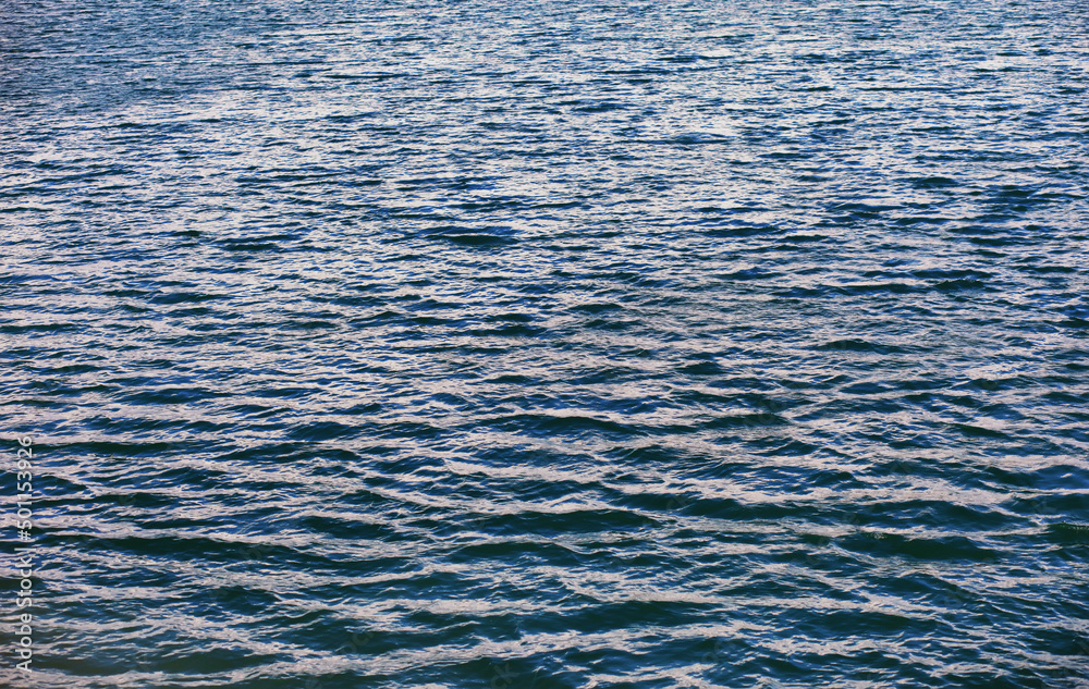 Water surface. The texture of the water. Waves on the lake in windy weather. Water surface. The texture of the water. Waves on the lake in windy weather.