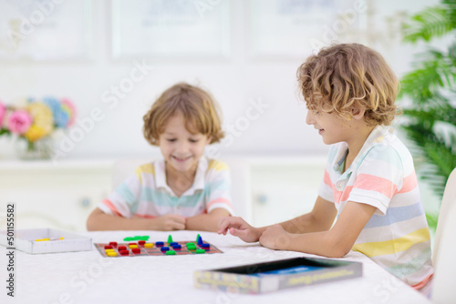 Family playing board game. Kids play.