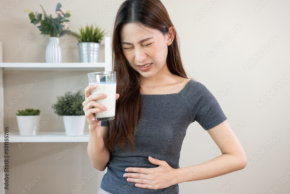 lactose intolerance concept. Woman having a stomachache because drink milk. lactose intolerance concept. Woman having a stomachache because drink milk.