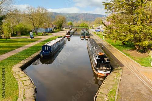 Narrowboats moored up on a tranquil leafy part of the Llangollen canal in the Trevor Basin at the Froncysyllte aqueduct on the inland waterway network in North Wales UK