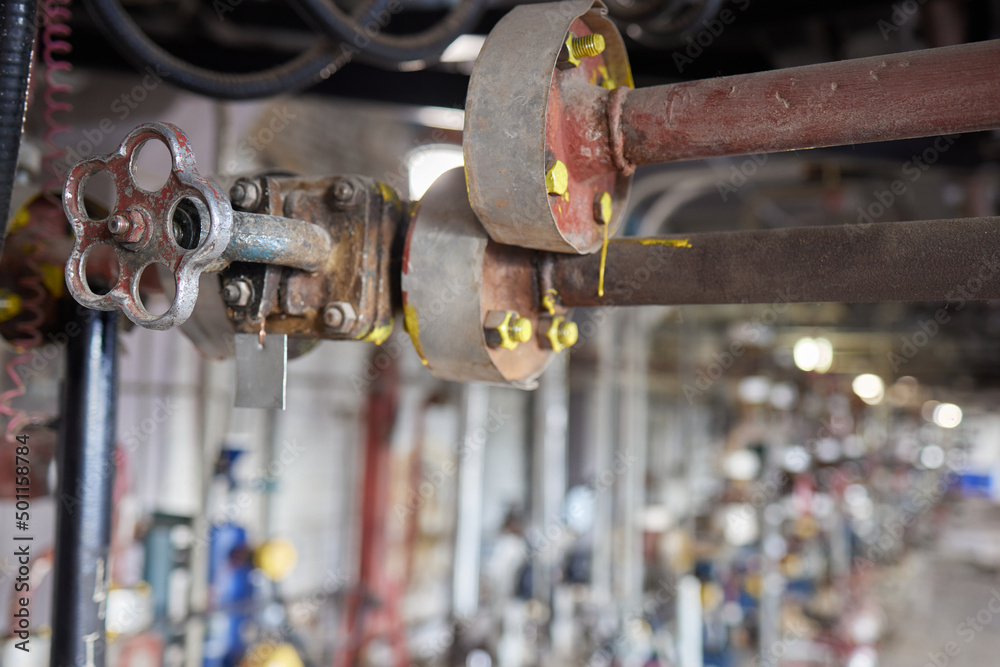 Valves In Refinery Close-up at pipeline valve which is using to control production process ...