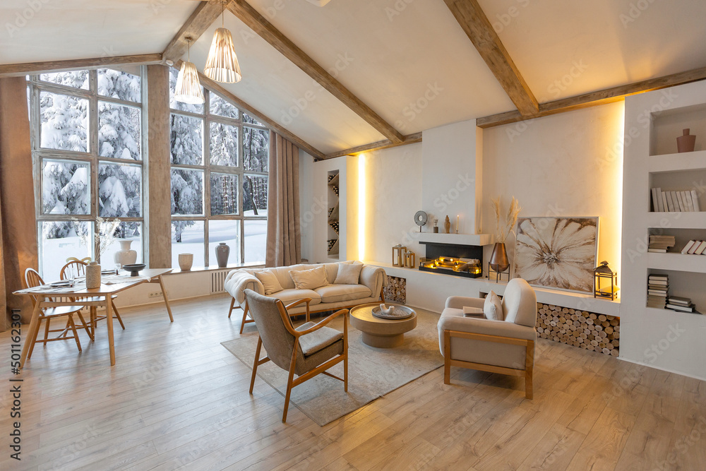 cozy warm home interior of a chic country chalet with a huge panoramic window overlooking the winter forest. open plan, wood decoration, warm colors and a family hearth cozy warm home interior of a chic country chalet with a huge panoramic window overlooking the winter forest. open plan, wood decoration, warm colors and a family hearth