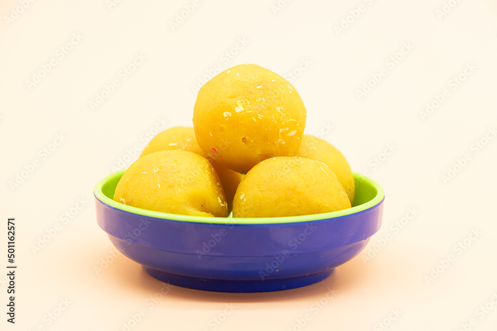 coconut laddoo isolate on colorful background