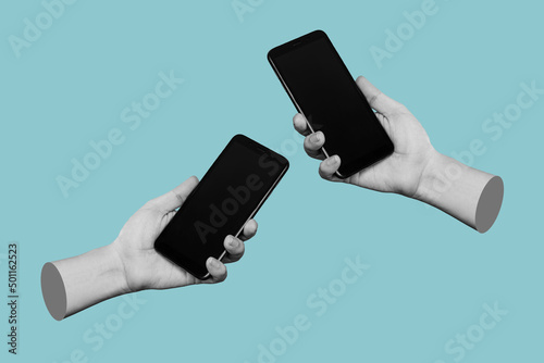 Canvas Print Two hands of women holding mobile phones with blank black screens, empty copy space for design isolated on a blue background