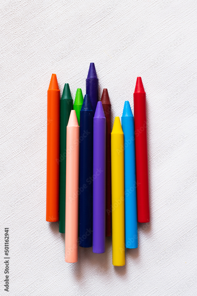 top view of colorful crayons on textured white background. top view of colorful crayons on textured white background.