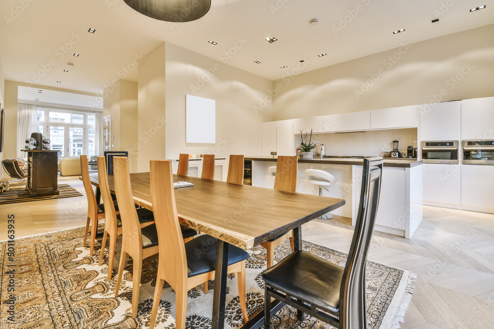 Interior of kitchen with various appliances and dinning table Interior of kitchen with various appliances and dinning table