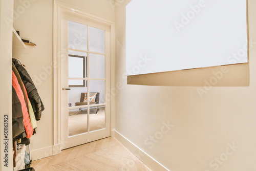 Hallway with clothes on rack with glass doors