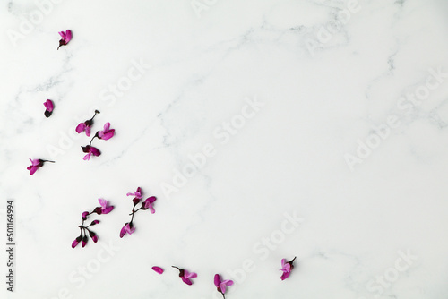 Flat lay product mock up with white marble and red bud flowers