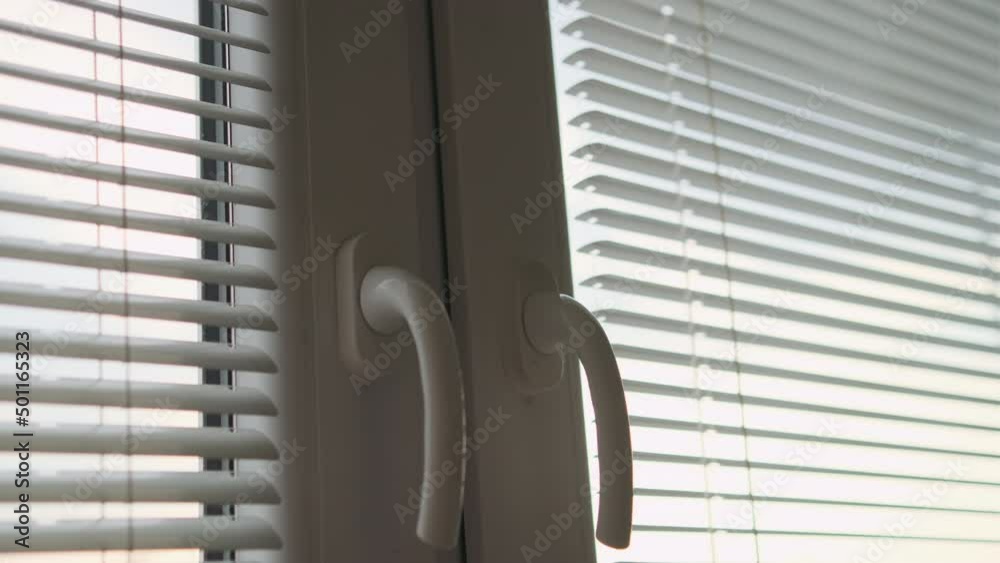 Close up man hand closing a window after home ventilation. Close up man hand closing a window after home ventilation.