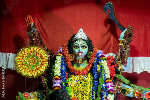 Kolkata,India - October 19, 2017 : Indian Hindu Goddess Kali is being worshipped inside decorated pandal, a temporary temple,at night. Kali Puja or Shyama Puja or Mahanisha Puja, is a Indian festival. photo
