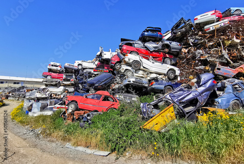 Pile of various scrap cars and other metals on a junk yard ready recycling industry.