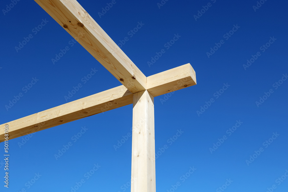 Wooden beams of construction structure, on background of blue sky Wooden beams of construction structure, on background of blue sky