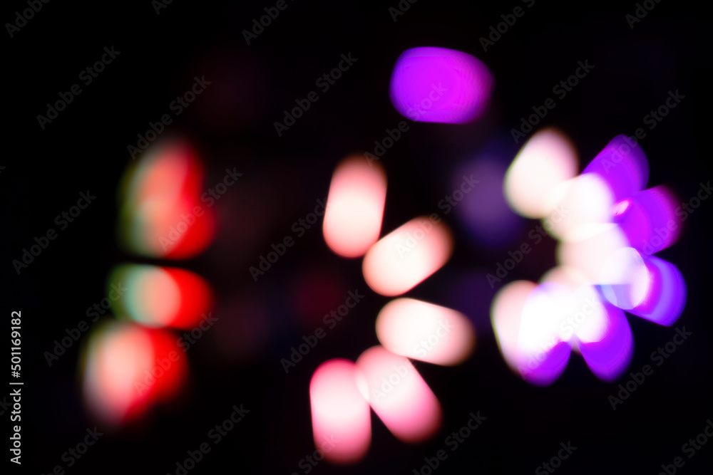 Multicolored defocused bokeh on a black background.